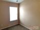 Neutral bedroom featuring carpeted floors and a large window for natural light at 13441 Calloway Glen Dr, Charlotte, NC 28273