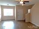 Bright living room featuring hardwood floors, a ceiling fan and lots of natural light at 13441 Calloway Glen Dr, Charlotte, NC 28273