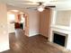 Inviting living area flowing into kitchen, featuring hardwood flooring & fireplace at 13441 Calloway Glen Dr, Charlotte, NC 28273