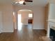 Open-concept living space with hardwood floors, fireplace, and kitchen access at 13441 Calloway Glen Dr, Charlotte, NC 28273