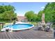 Inviting backyard deck with a pool, patio set, and detached garage, perfect for outdoor relaxation and entertaining at 136 Barringer Dr, Statesville, NC 28625