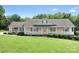 Inviting home showcasing a spacious front porch with white railing and green shutters at 136 Barringer Dr, Statesville, NC 28625