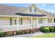 Charming front porch with decorative columns, manicured shrubs and inviting entrance at 136 Barringer Dr, Statesville, NC 28625