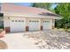 Spacious three-car garage with white doors and brick accents near lush greenery at 136 Barringer Dr, Statesville, NC 28625