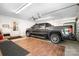 Spacious garage with a truck, ceiling fan, a door to the yard, and wooden-like tiles on the floor at 136 Barringer Dr, Statesville, NC 28625