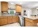 Kitchen features wooden cabinets, stainless dishwasher, and double sink at 136 Barringer Dr, Statesville, NC 28625