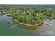 Breathtaking aerial view highlighting the property's shoreline and tranquil lake setting at 145 Hunters Pointe Ln, Mooresville, NC 28117