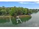 Aerial view of a green dock on a lake, nestled among lush trees and serene waters at 145 Hunters Pointe Ln, Mooresville, NC 28117