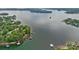 Aerial shot of a serene lake, showcasing clear waters and lush green shorelines with docks at 145 Hunters Pointe Ln, Mooresville, NC 28117