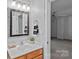 This cozy bathroom features a well-lit vanity and a framed mirror, offering comfort and functionality at 145 Hunters Pointe Ln, Mooresville, NC 28117