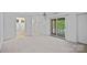 Large bedroom with balcony access and an ensuite bathroom for added convenience and privacy at 145 Hunters Pointe Ln, Mooresville, NC 28117