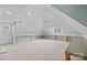 Bright bonus room with vaulted ceilings, recessed lighting, neutral carpet, and built in work spaces at 145 Hunters Pointe Ln, Mooresville, NC 28117