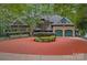 Stunning two-story home featuring a circular driveway, three-car garage and lush landscaping at 145 Hunters Pointe Ln, Mooresville, NC 28117