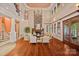 Grand living room featuring a stone fireplace, hardwood floors, lake views, and high ceilings at 145 Hunters Pointe Ln, Mooresville, NC 28117