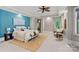 Bright main bedroom with a large bed, seating area, and natural light at 145 Hunters Pointe Ln, Mooresville, NC 28117