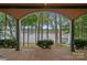 Covered porch with scenic views of the lake, dock, and landscaped yard at 145 Hunters Pointe Ln, Mooresville, NC 28117