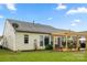 This backyard offers a patio with pergola, grassy lawn, and views of neighboring homes at 15152 Legend Oaks Ct, Indian Land, SC 29707