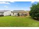 Well-maintained backyard features a green lawn and a cozy patio with a wooden pergola at 15152 Legend Oaks Ct, Indian Land, SC 29707