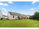 Landscaped backyard includes a patio with pergola, green lawn, and well-maintained landscaping at 15152 Legend Oaks Ct, Indian Land, SC 29707