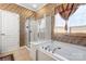 A bathroom features a shower, separate tub, and a patterned wall at 15152 Legend Oaks Ct, Indian Land, SC 29707