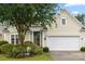 This home boasts charming curb appeal with a neatly landscaped yard and an attached two-car garage at 15152 Legend Oaks Ct, Indian Land, SC 29707