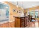 Kitchen island featuring stylish lighting and a breakfast bar next to a dining area at 15152 Legend Oaks Ct, Indian Land, SC 29707