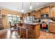 A cozy kitchen featuring wood cabinets, an island with stools, and a breakfast nook near bright windows at 15152 Legend Oaks Ct, Indian Land, SC 29707