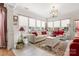 Bright living room with a white sofa, red accents, and ample natural light at 15152 Legend Oaks Ct, Indian Land, SC 29707