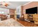 Comfortable living room with a fireplace, hardwood floors, and cozy seating arrangement at 15152 Legend Oaks Ct, Indian Land, SC 29707