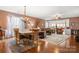 Elegant living and dining area featuring hardwood floors, chandelier, and plush furniture for comfortable gatherings at 15152 Legend Oaks Ct, Indian Land, SC 29707
