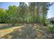Spacious backyard featuring a pergola, seating areas, and lush greenery, offering privacy at 1543 Ab Moore Jr Dr, Indian Trail, NC 28079