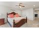 Spacious bedroom features an elegant bed, ceiling fan and ensuite bathroom access at 1543 Ab Moore Jr Dr, Indian Trail, NC 28079