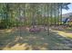 Backyard pergola offering a tranquil seating area amidst a lush, tree-lined landscape at 1543 Ab Moore Jr Dr, Indian Trail, NC 28079