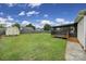 Large grassy backyard has privacy fence, shed, and screened-in back porch at 1744 Marsley Ln, Rock Hill, SC 29730