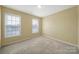 A bedroom with carpeted floors and two windows at 1744 Marsley Ln, Rock Hill, SC 29730