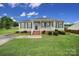 Charming single-story home with a welcoming front porch and well-manicured lawn at 1744 Marsley Ln, Rock Hill, SC 29730