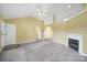 Bright living room featuring neutral carpet, ceiling fan, and fireplace at 1744 Marsley Ln, Rock Hill, SC 29730