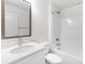 White bathroom featuring a shower and tub combo, vanity with a white countertop, and framed mirror at 1815 Wildwood Dr, Charlotte, NC 28214