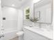 Bright bathroom featuring a tub, shower, and modern vanity with a white countertop and brushed nickel faucet at 1815 Wildwood Dr, Charlotte, NC 28214