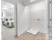 Walk-in closet with white wire rack shelving beside a door into a bedroom with a tray ceiling at 1815 Wildwood Dr, Charlotte, NC 28214