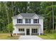 Charming two-story home featuring a welcoming front porch, black shutters, and a freshly landscaped yard at 1815 Wildwood Dr, Charlotte, NC 28214