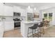 Bright kitchen featuring a center island with seating, stainless steel appliances, and adjacent dining area at 1815 Wildwood Dr, Charlotte, NC 28214