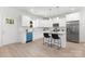 Modern kitchen with white cabinets, stainless steel appliances, and a functional island with bar seating at 1815 Wildwood Dr, Charlotte, NC 28214