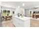 Open-concept kitchen with white island extends to a dining area and living space with lots of natural light at 1815 Wildwood Dr, Charlotte, NC 28214