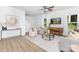 Bright living room featuring modern furniture, neutral tones, a ceiling fan, and natural light from windows at 1815 Wildwood Dr, Charlotte, NC 28214
