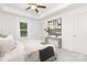 Bright bedroom with plush carpet, a tray ceiling with fan and a decorative console table beneath abstract art at 1815 Wildwood Dr, Charlotte, NC 28214