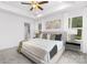 Main bedroom with tray ceilings, a ceiling fan, carpet floors, and a view into the bathroom at 1815 Wildwood Dr, Charlotte, NC 28214