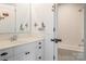 Bright bathroom with a stylish vanity, wainscoting, and subway-tiled shower/bath at 1833 The Plz, Charlotte, NC 28205