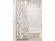 Bright bathroom featuring a white subway-tiled shower, patterned shower curtain, and classic fixtures at 1833 The Plz, Charlotte, NC 28205