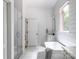 Elegant bathroom with a freestanding tub, shiplap walls, marble floors, and a glass shower at 1833 The Plz, Charlotte, NC 28205